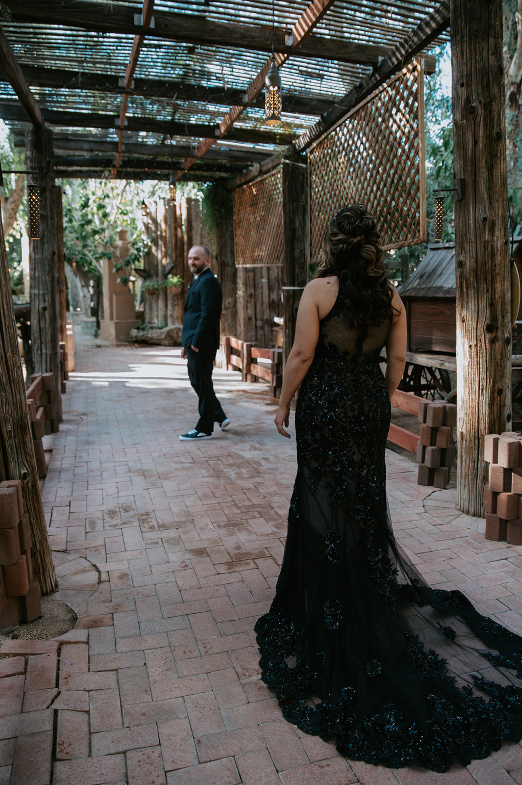 Bride walking toward her groom for an emotional first look at boojum tree hidden gardens.

