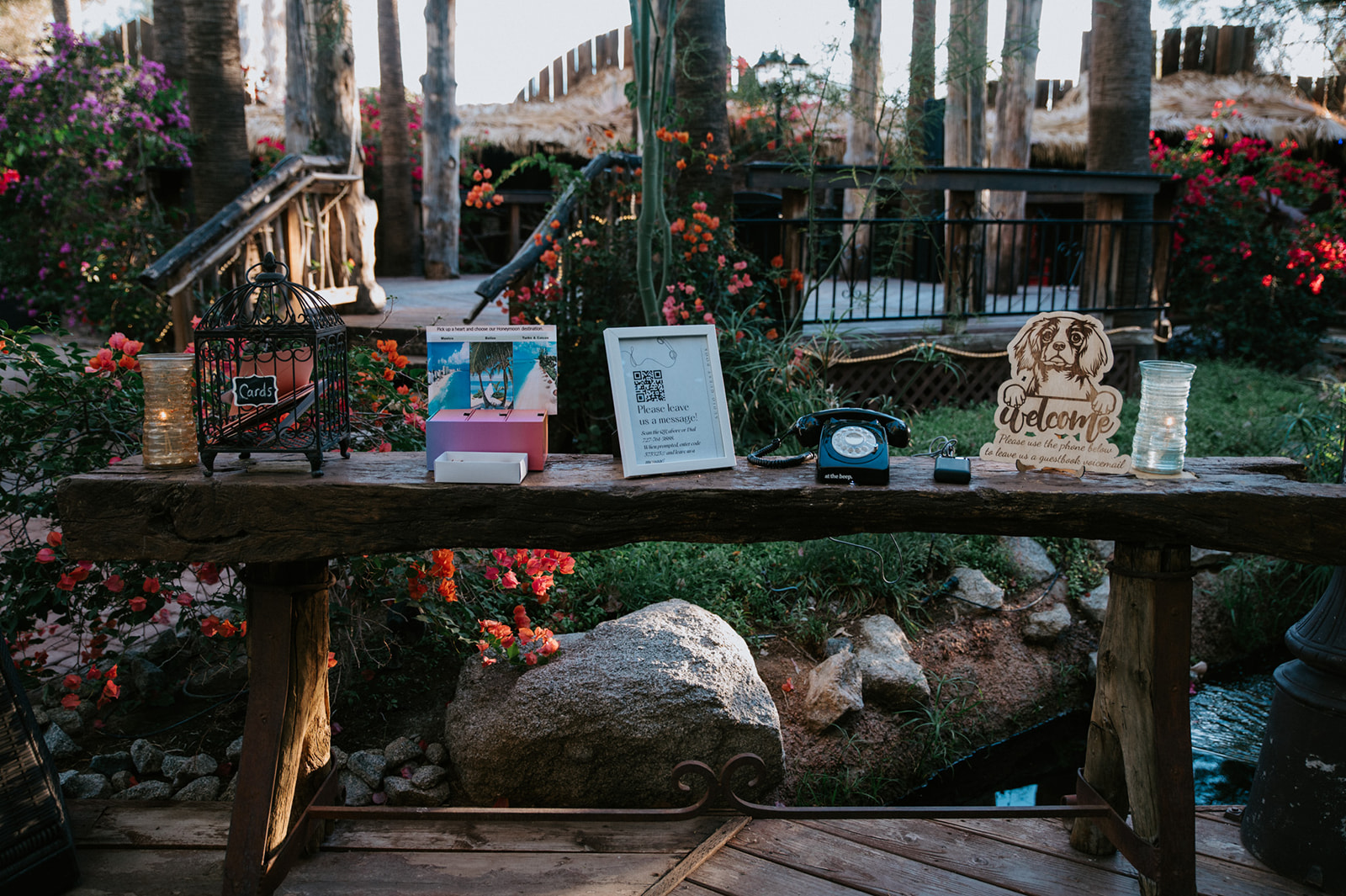 Rustic wedding welcome table featuring cards, guestbook, audio guestbook, and personalized décor.
