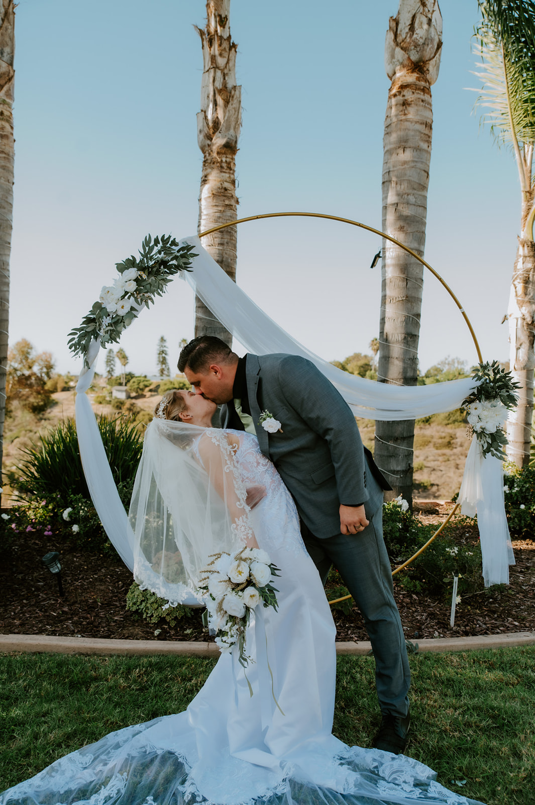 Bride and groom kissing during their family ceremony at an Airbnb wedding, a real-life example of how to plan an elopement with family without losing intimacy.