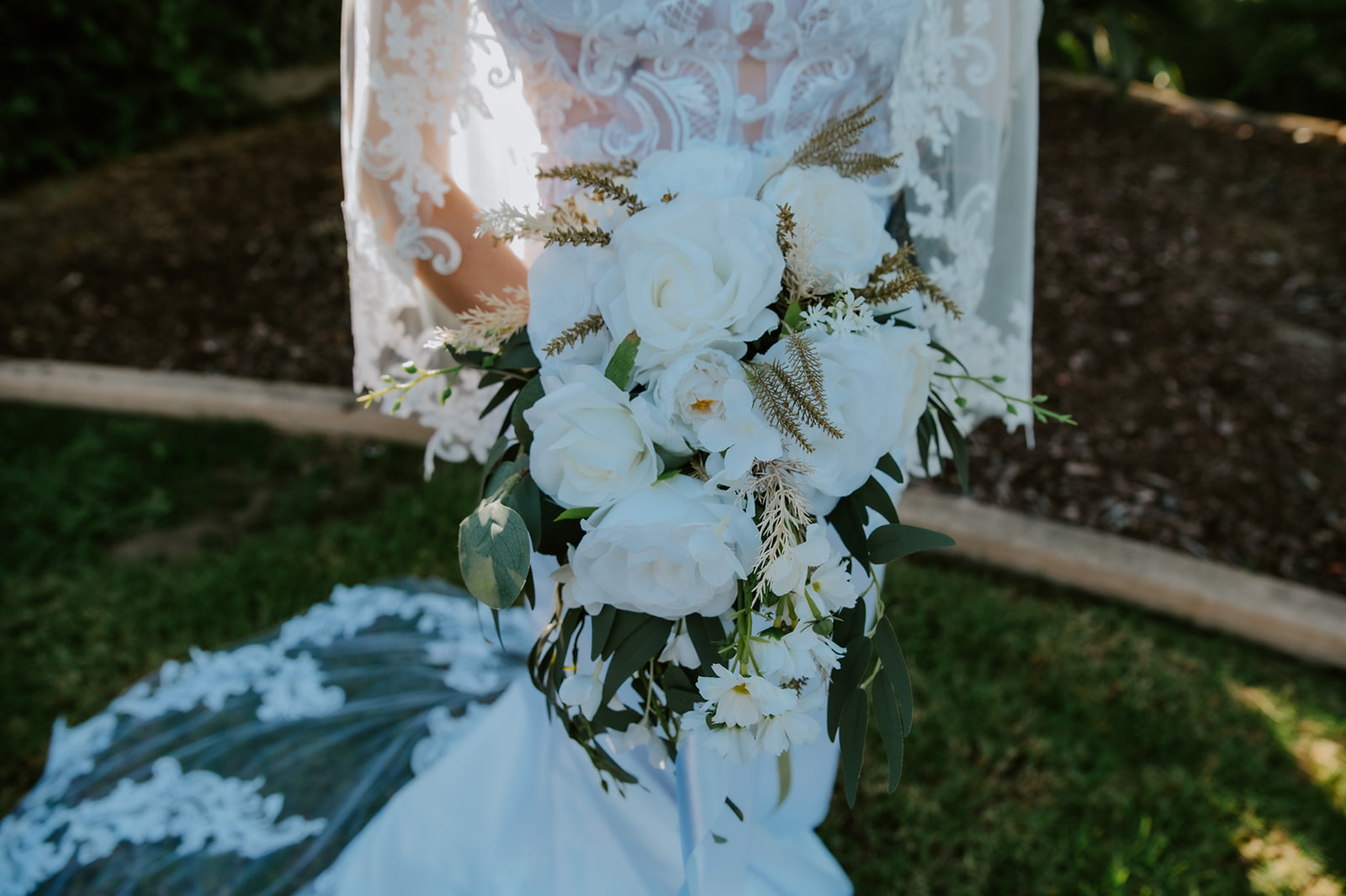 Close-up of bridal bouquet and lace wedding dress details from a California elopement day that included both family time and private portraits