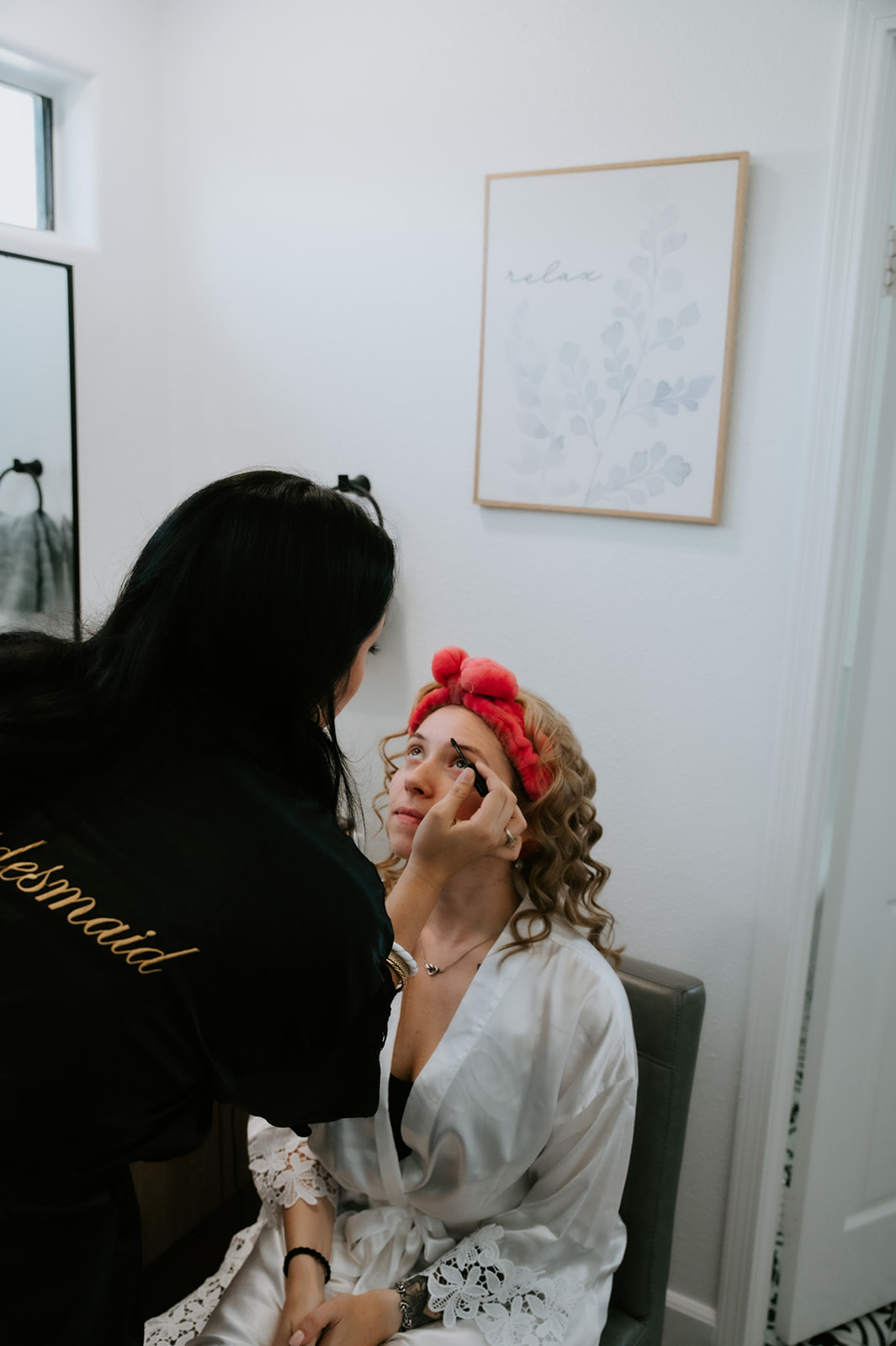 Bride getting her makeup done inside an Airbnb before a family-inclusive elopement day, highlighting calm, slow moments before the ceremony.