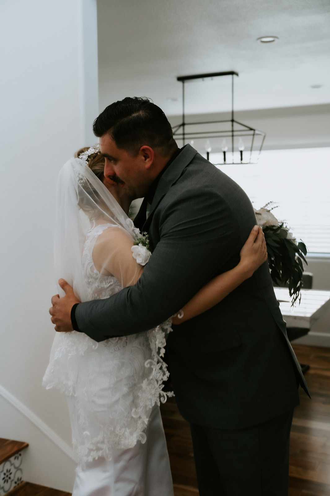 Couple hugging during their first look inside the Airbnb, a calm, emotional moment that reflects how to plan an elopement with family while protecting connection.
