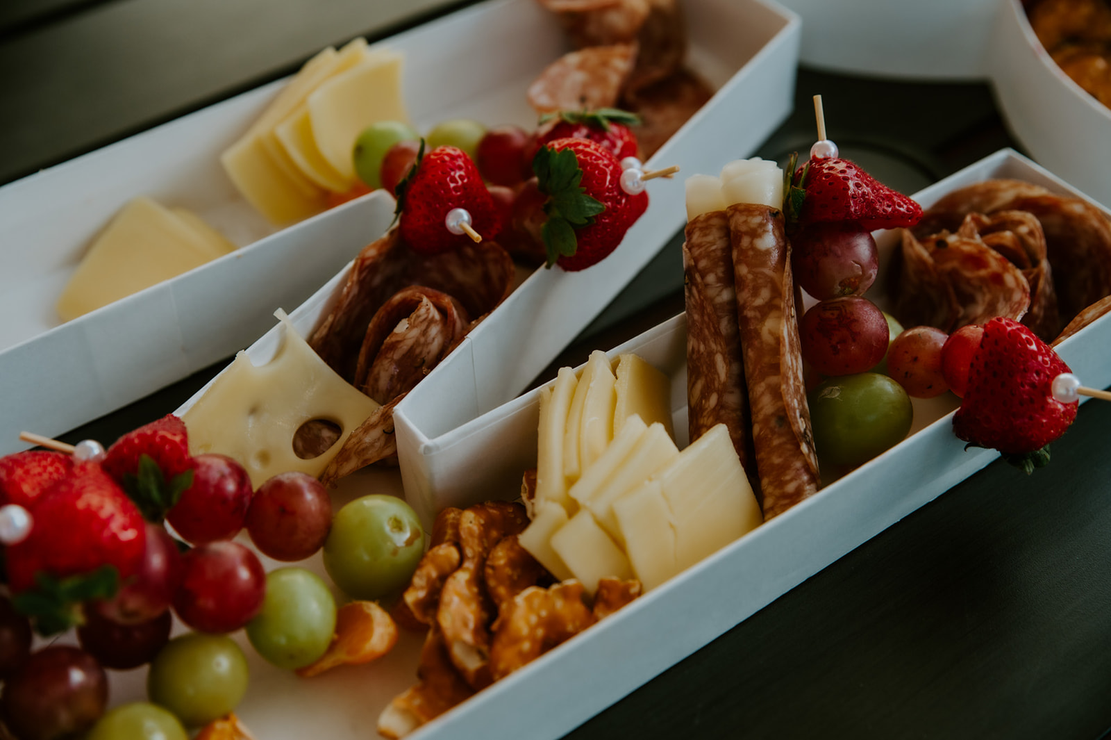 Grazing boxes with fruit, cheese, and snacks served during an Airbnb elopement reception with family