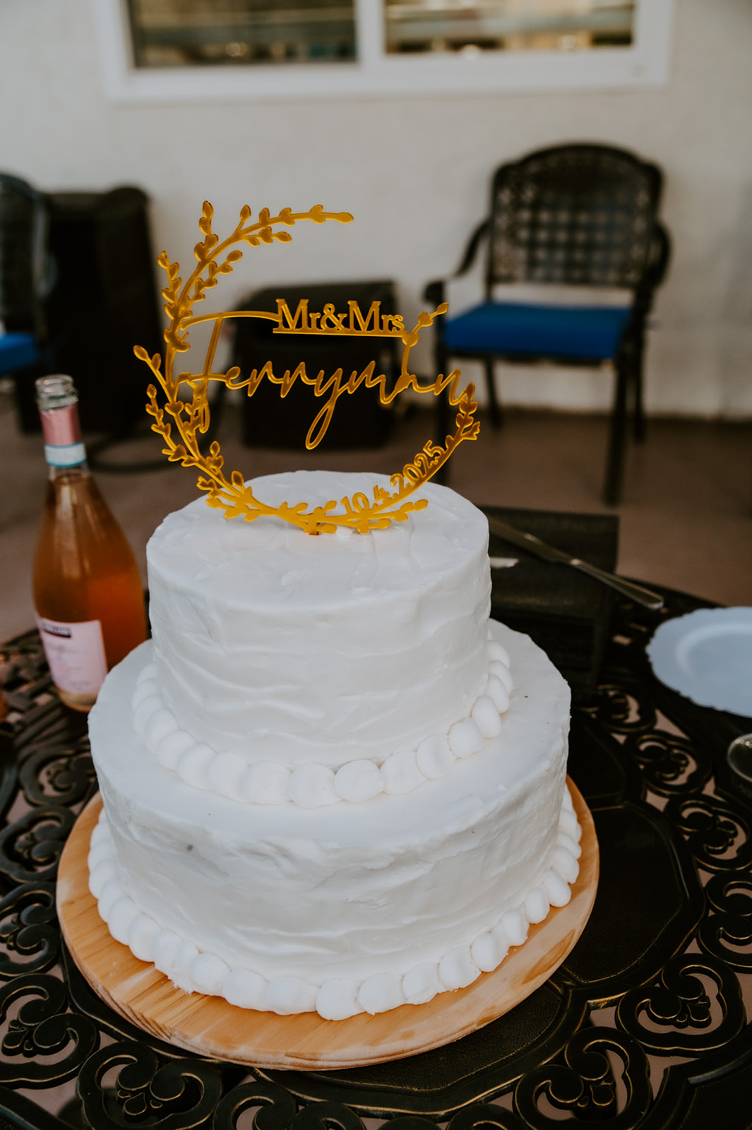 Simple two-tier wedding cake displayed during an Airbnb wedding reception with family in Southern California.