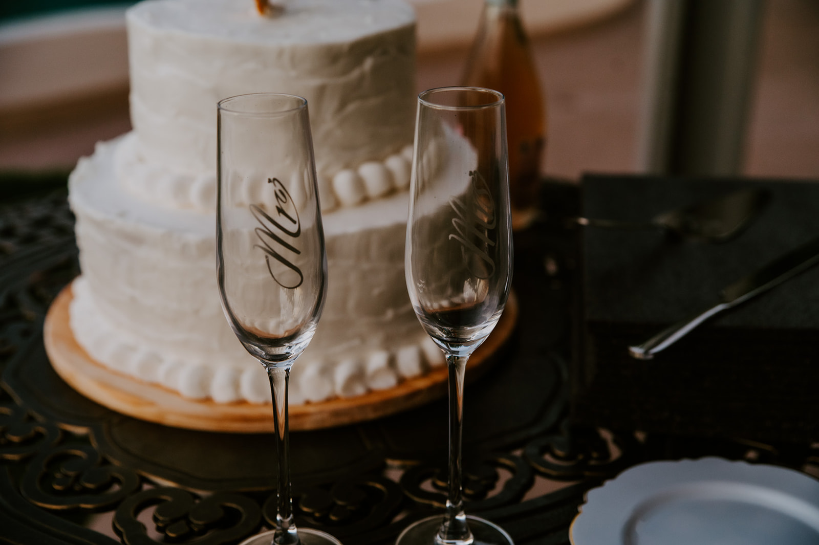 Close-up of the wedding cake table with champagne flutes during an Airbnb wedding celebration