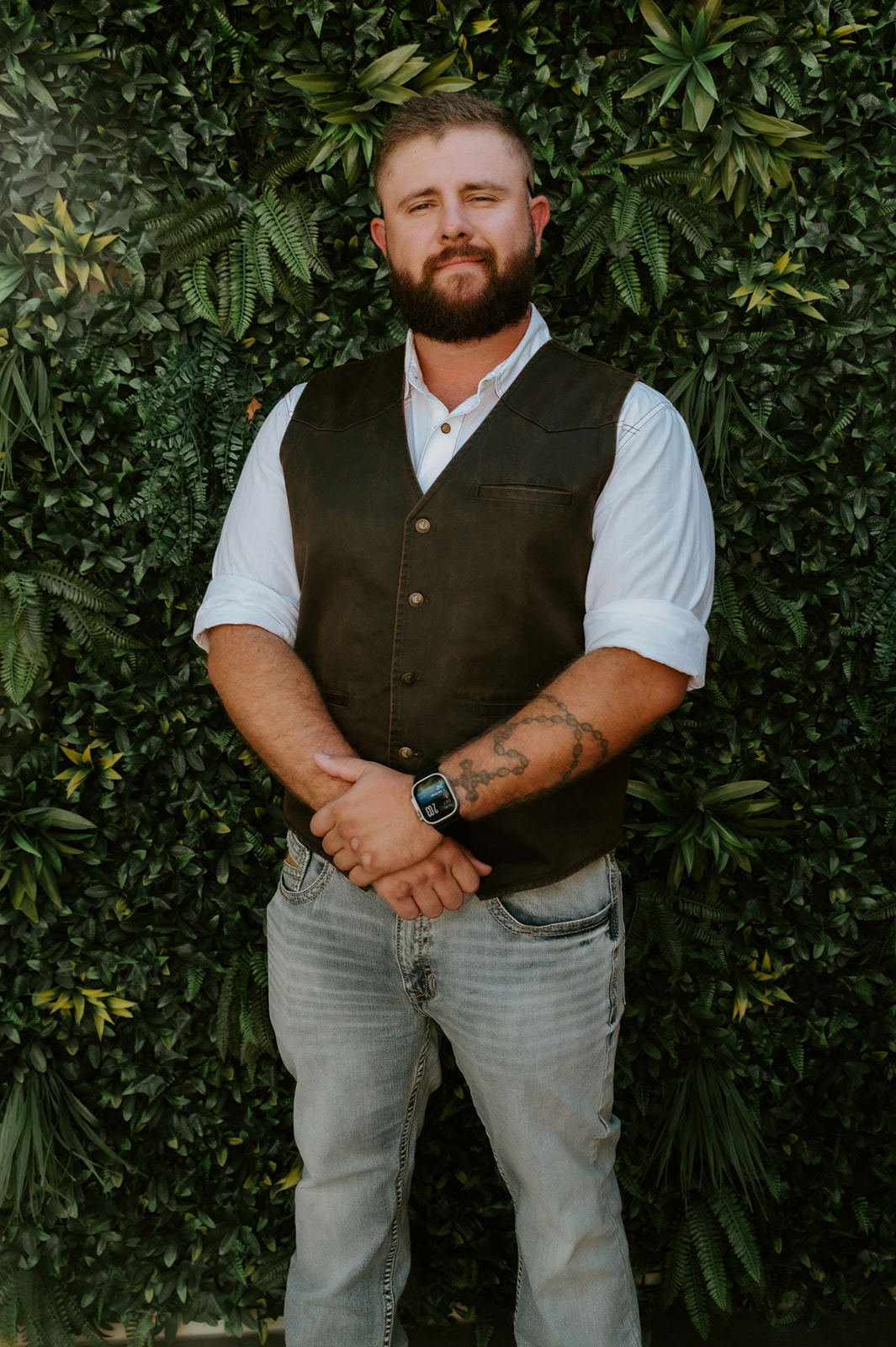 Groom crossing hands in front of him and smiling before first look with his bride captured by California elopement photographer. 