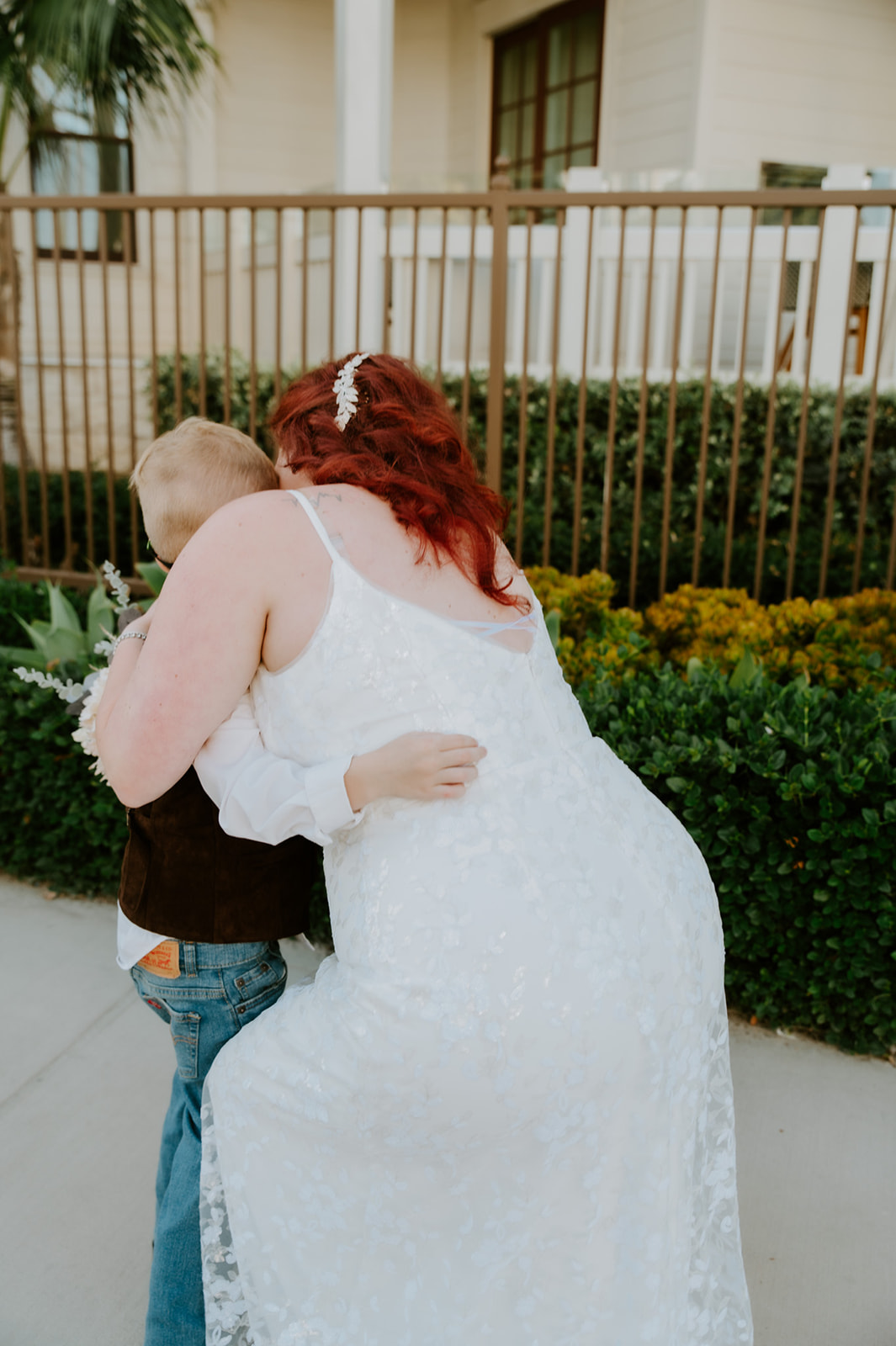 Bride hugs son after he sees her in her wedding dress for the first time. 