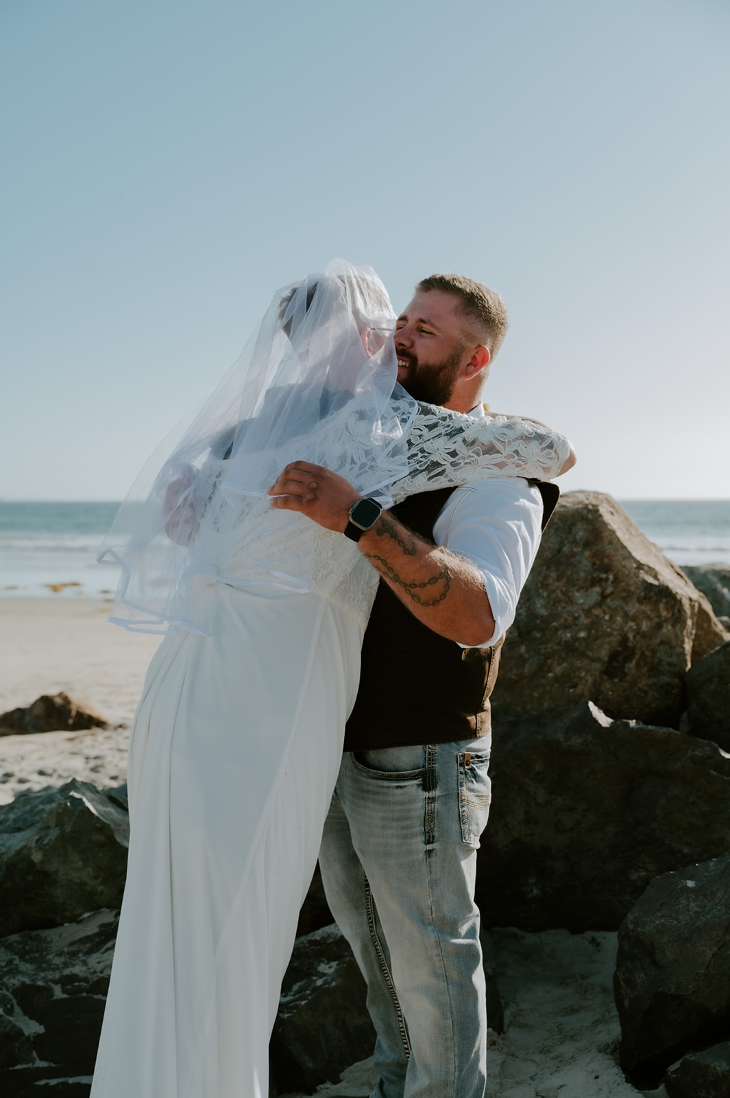Groomsmen wearing wedding dress to surprise groom and hugging him.