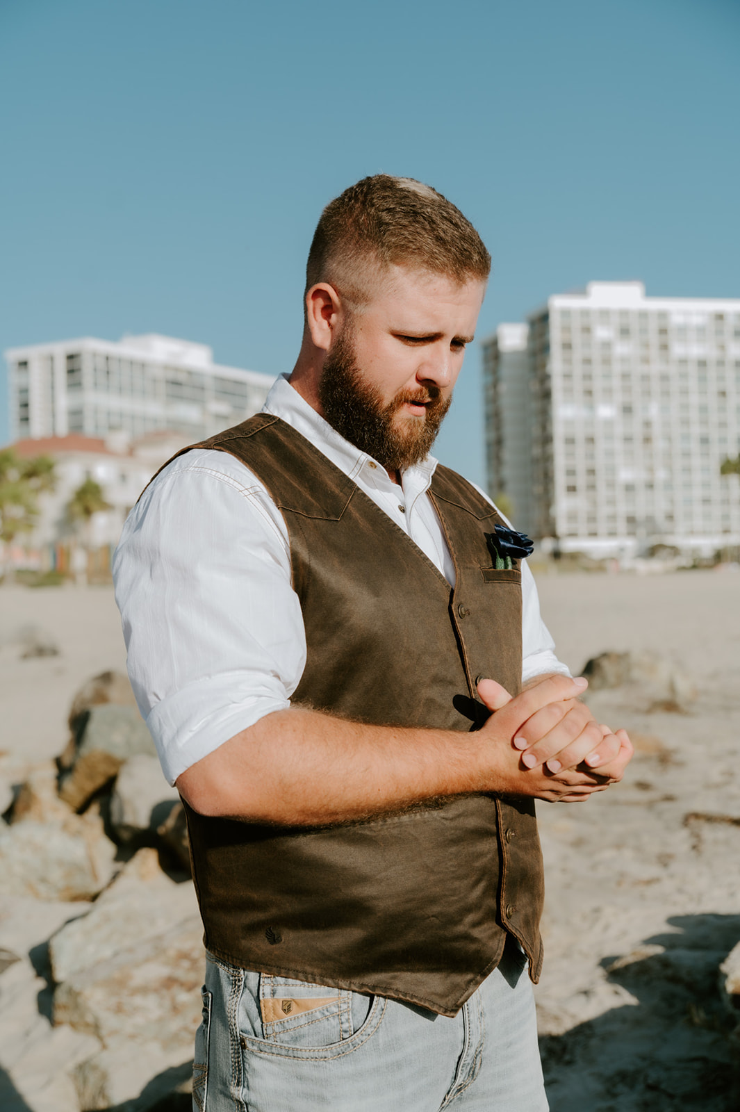 Groom adjusting his hands nervously before the ceremony during an intimate California elopement.