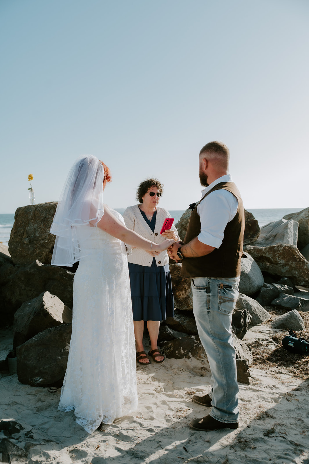 Close up of bride and groom during intimate beach wedding in California. 