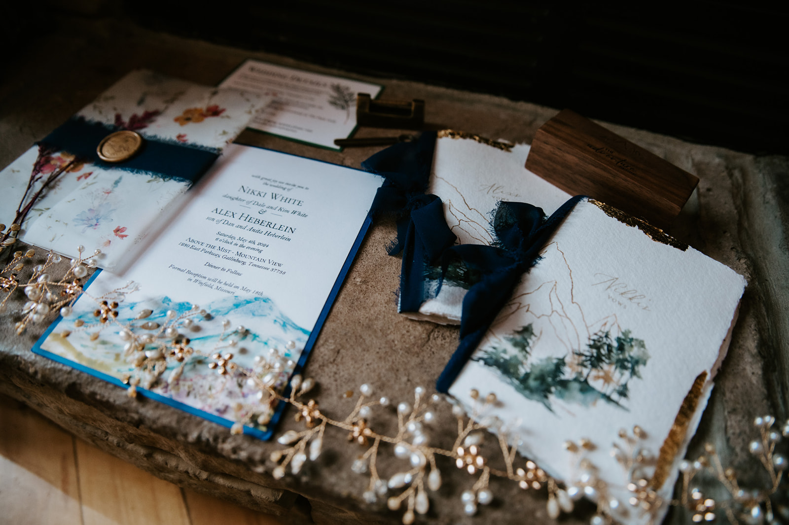 Flat lay of elopement details including invitations, vow books, and jewelry, styled with soft textures and natural tones.