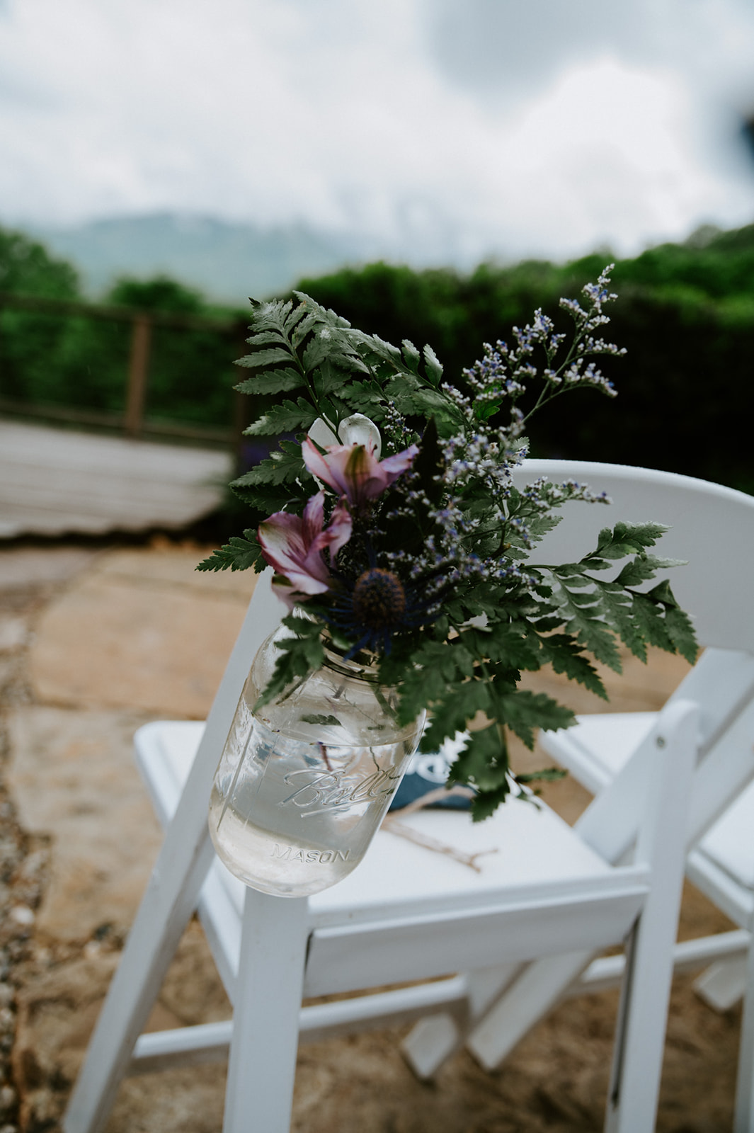 Mason jar floral arrangement attached to ceremony chairs overlooking the Smoky Mountains.