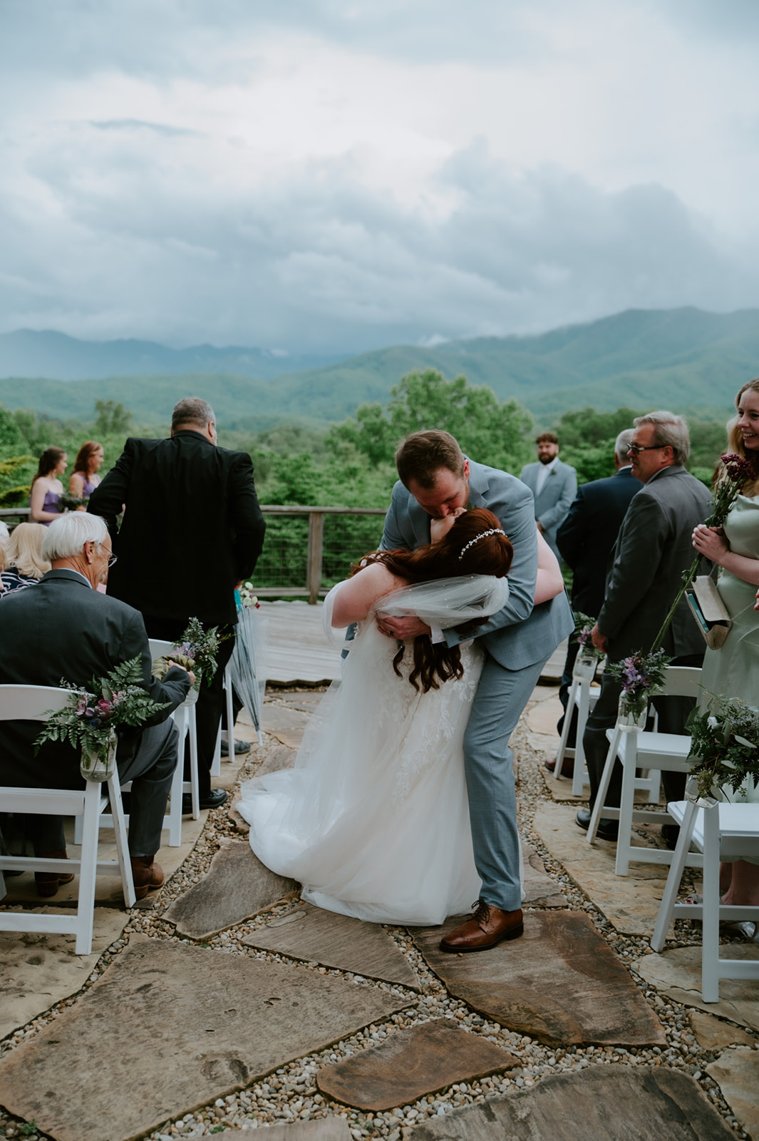 Couple celebrating their marriage with a joyful dip kiss during recessional at a Smoky Mountain elopement.