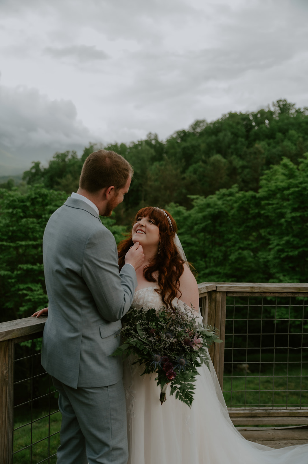 Groom gently lifting the bride’s chin during portraits after their Smoky Mountain ceremony.