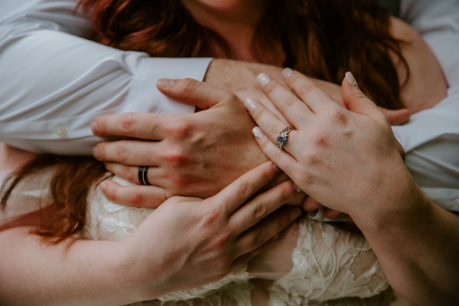 Close-up of the couple’s hands and engagement rings as they hold each other during their Smoky Mountain elopement.
