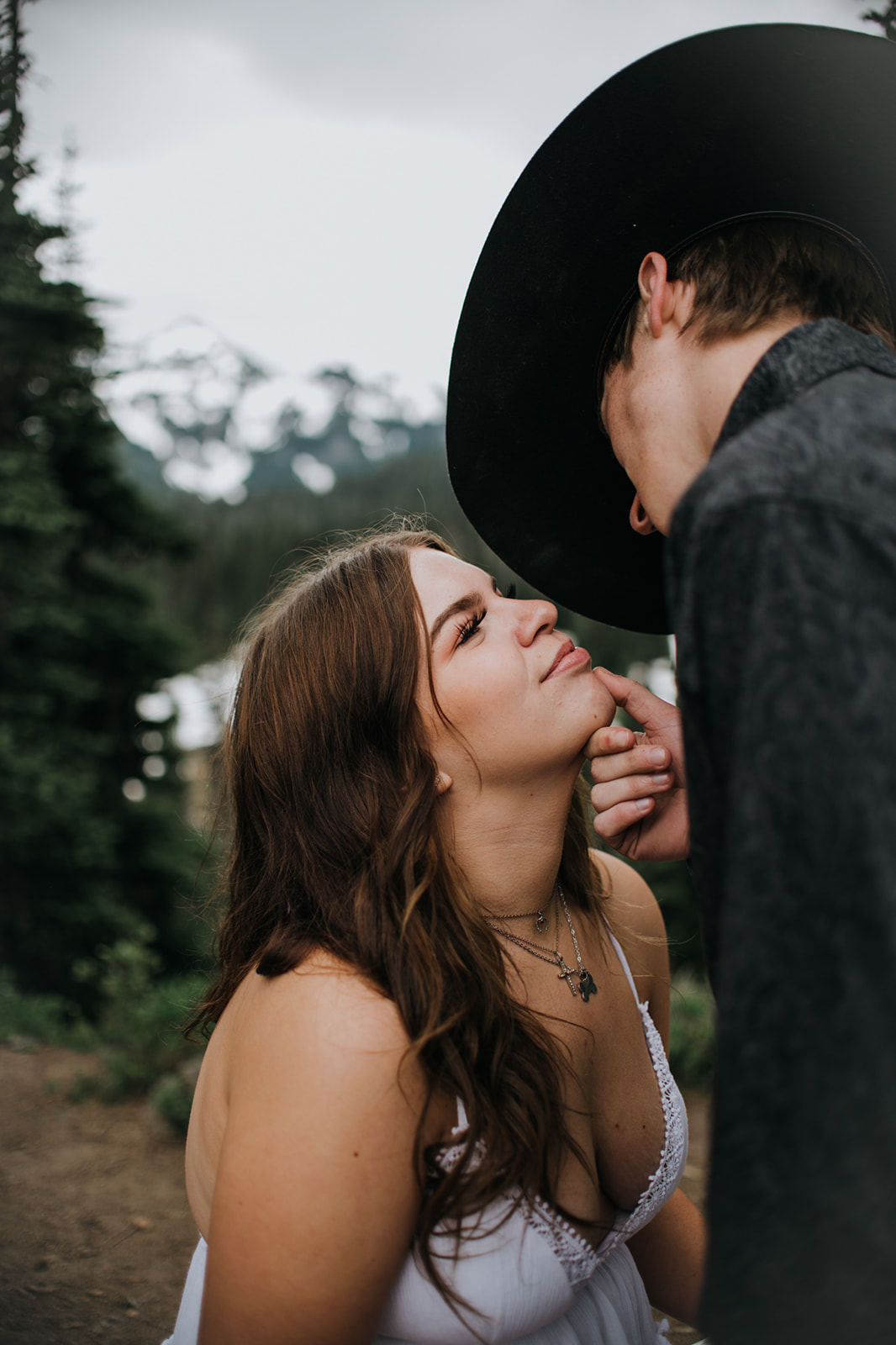 Intimate close-up of a couple sharing a soft moment in the forest during an adventurous Washington elopement.