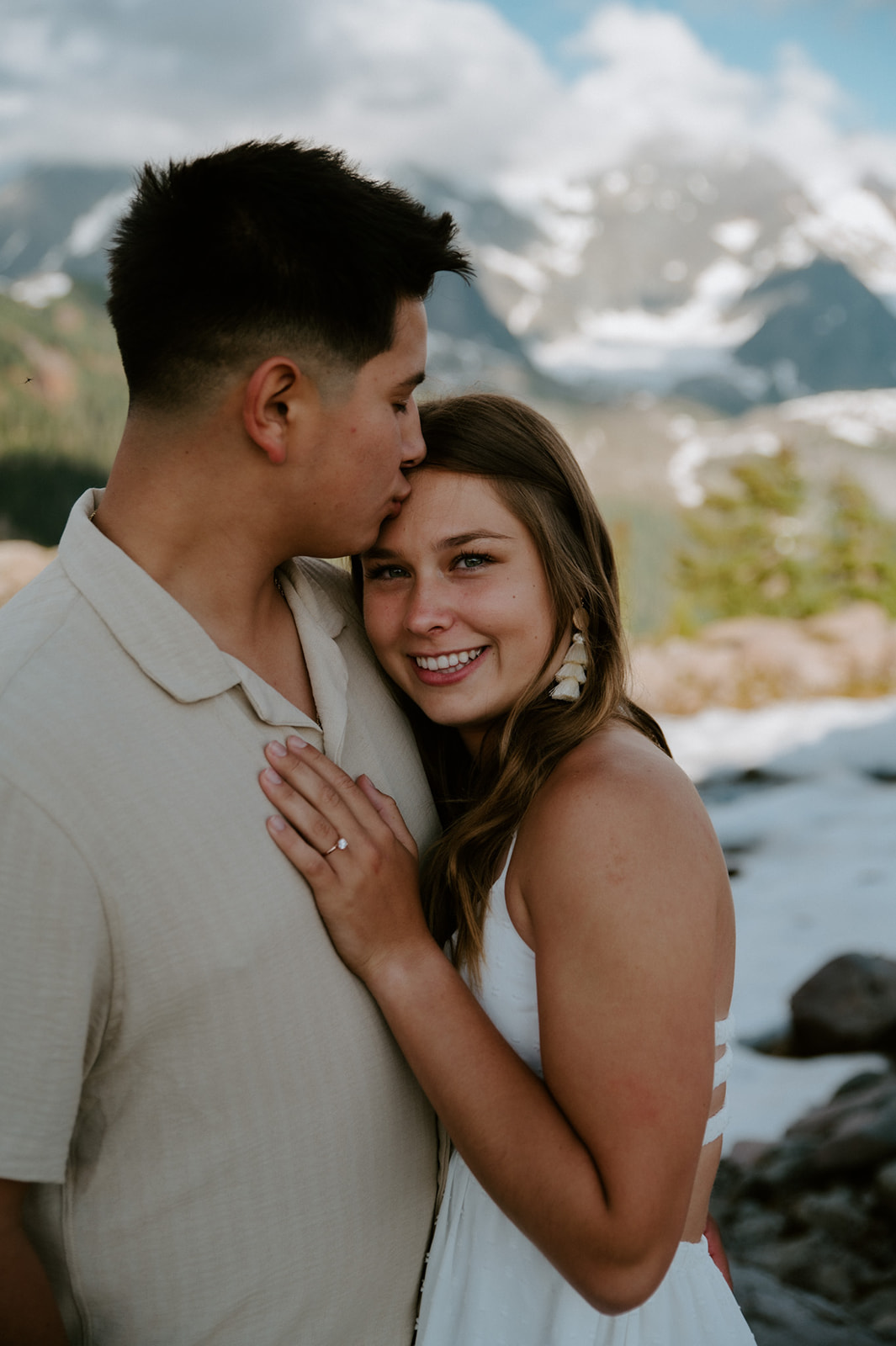 Close portrait of couple holding each other with snowy North Cascades peaks in the background during a north cascades elopement