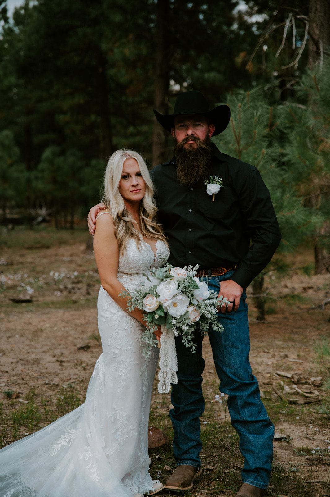 Bride and groom posing together in a pine forest after choosing to elope in Arizona.