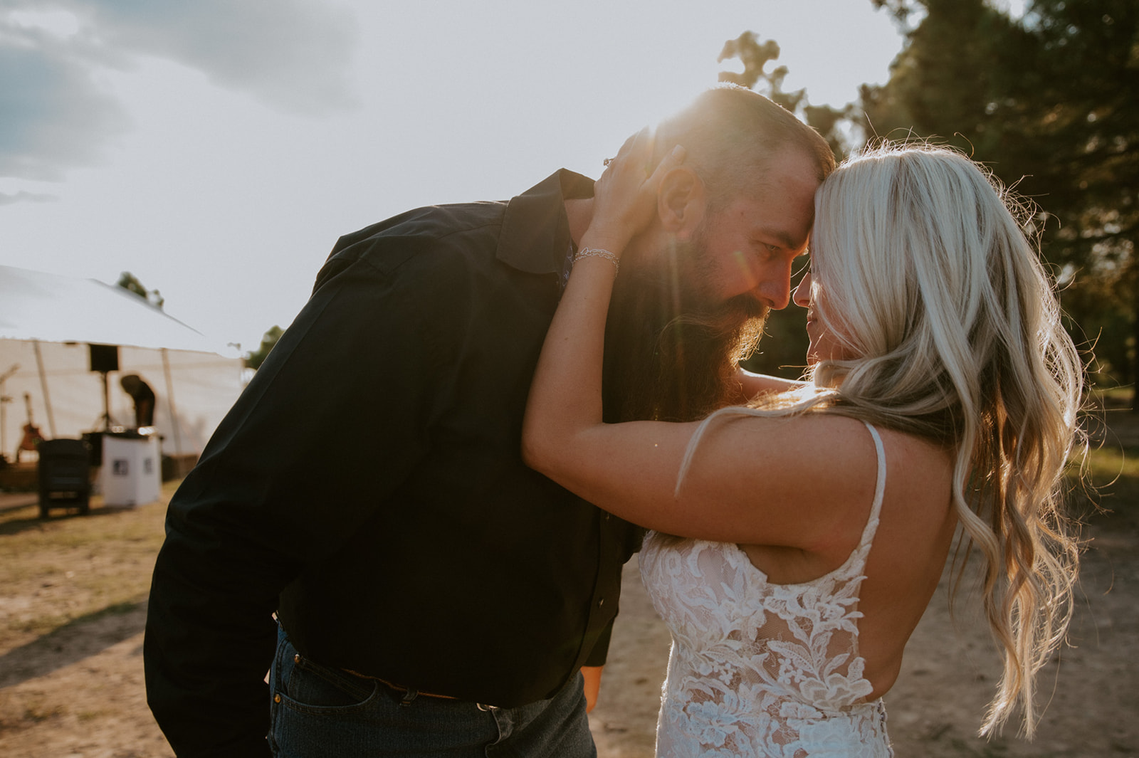 Golden hour portrait of bride and groom touching foreheads in warm sunset light as they elope in Arizona.