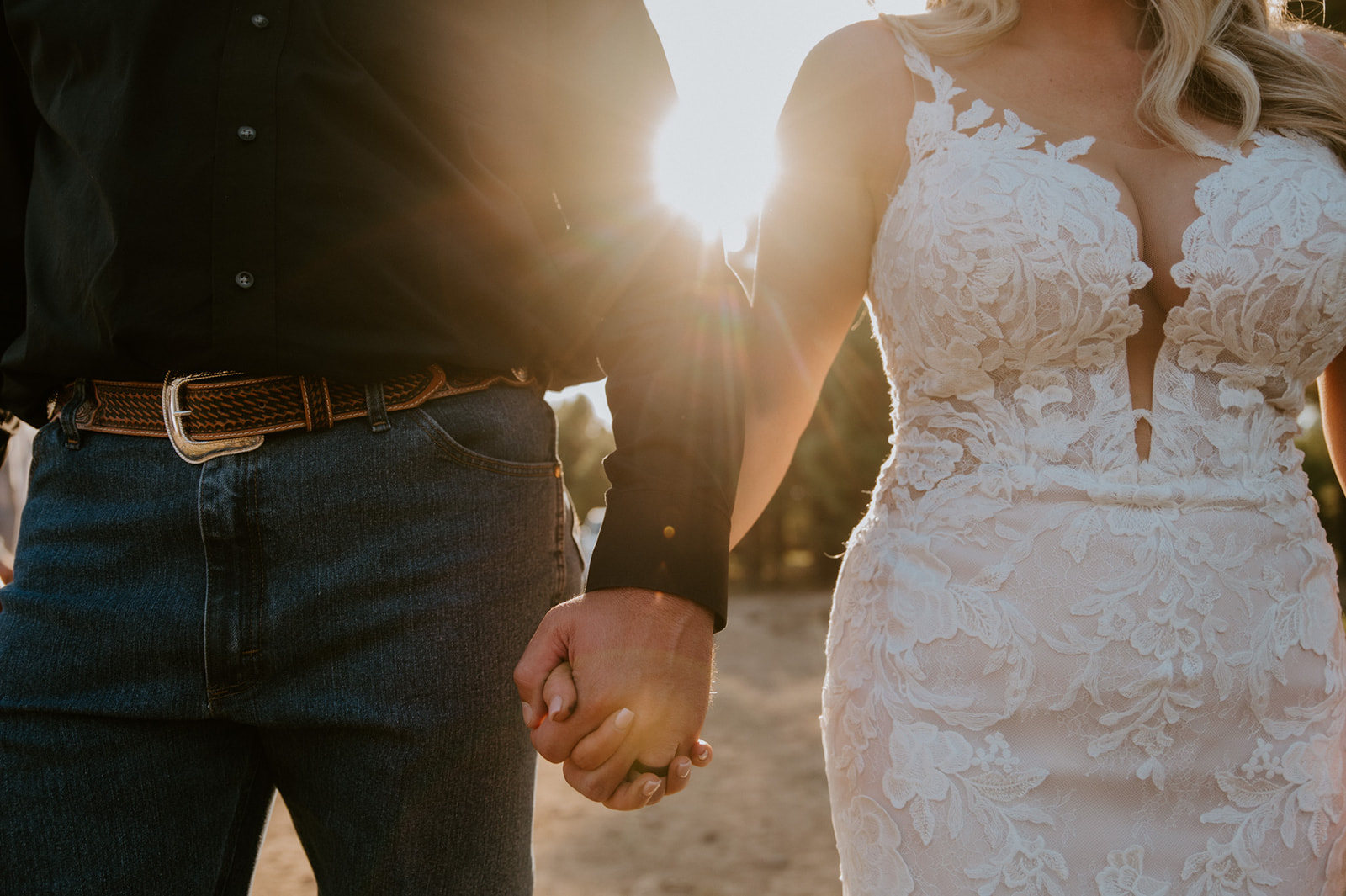 Close-up of bride and groom holding hands at sunset during their forest elopement in Arizona.