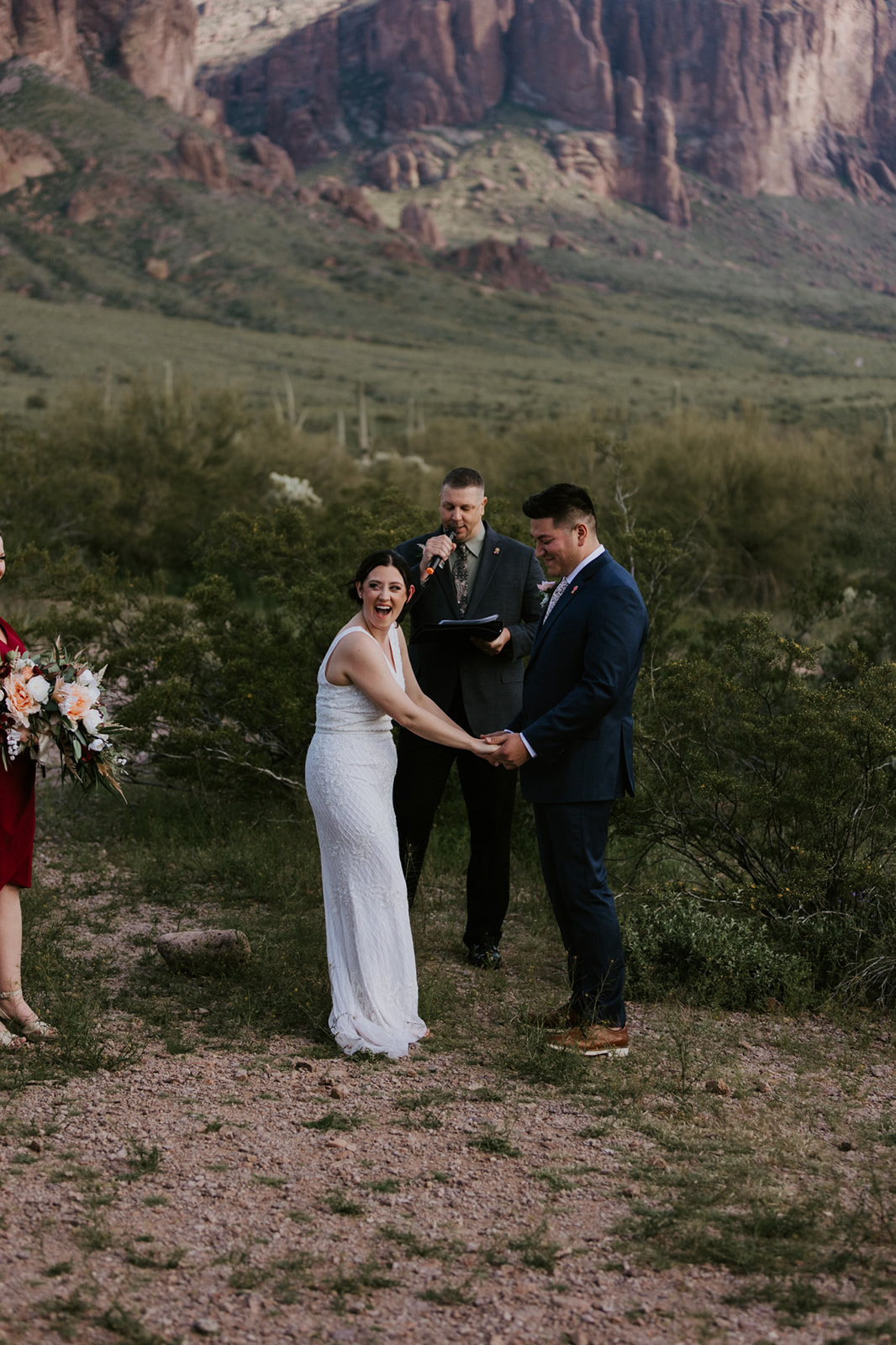 Arizona elopement ceremony in the desert with officiant and red rock mountains in the background