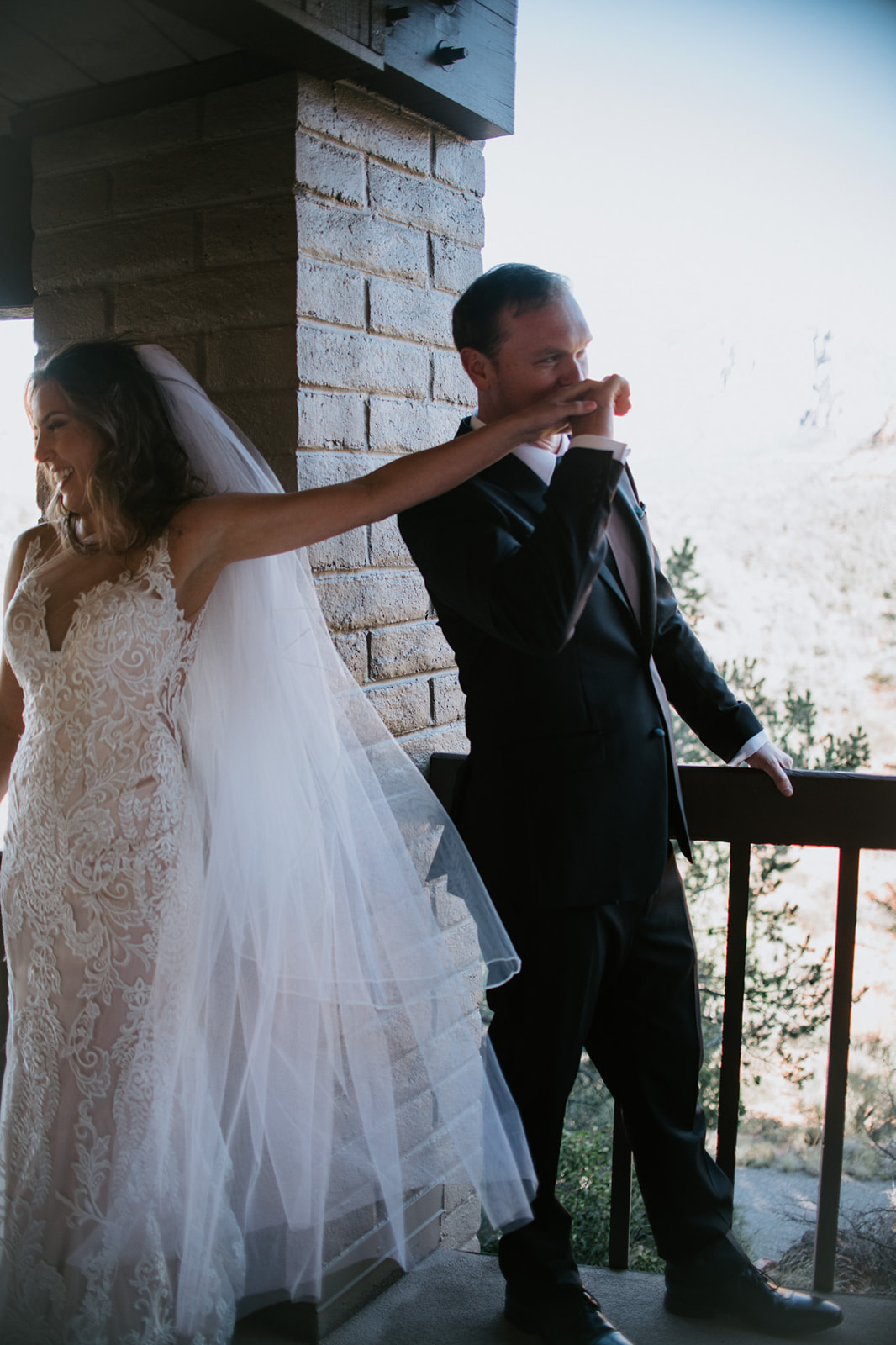 Couple sharing a quiet, emotional moment together on a balcony during their elopement in Arizona
