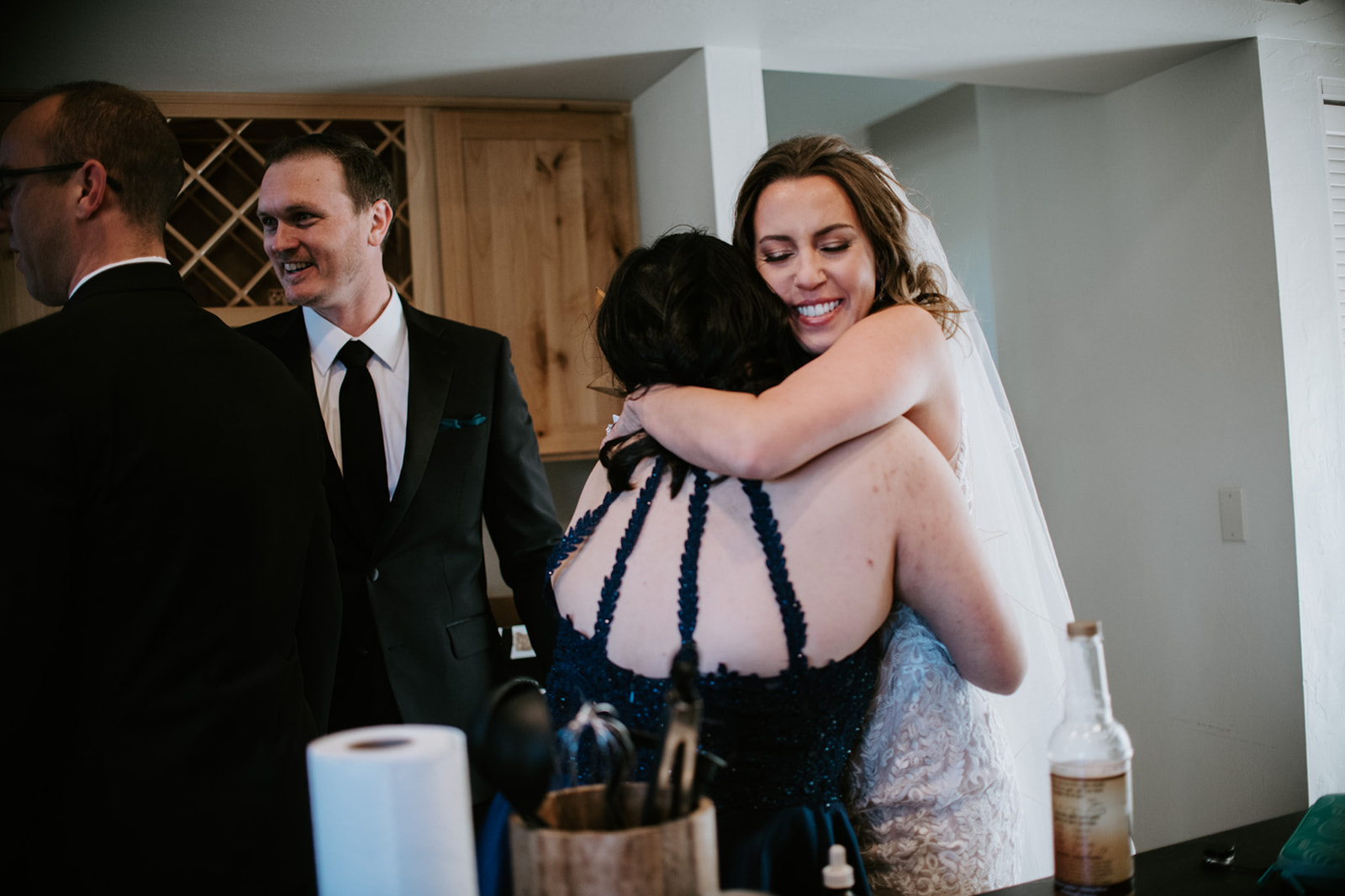 Bride hugging a guest and smiling during post-ceremony moments at an Airbnb elopement in Arizona