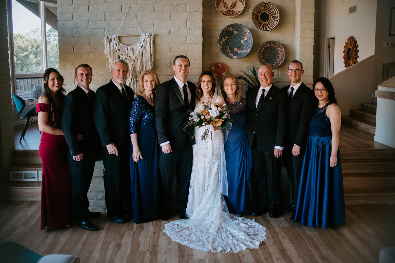 Family gathered indoors for group photos after an intimate Airbnb elopement in Arizona

