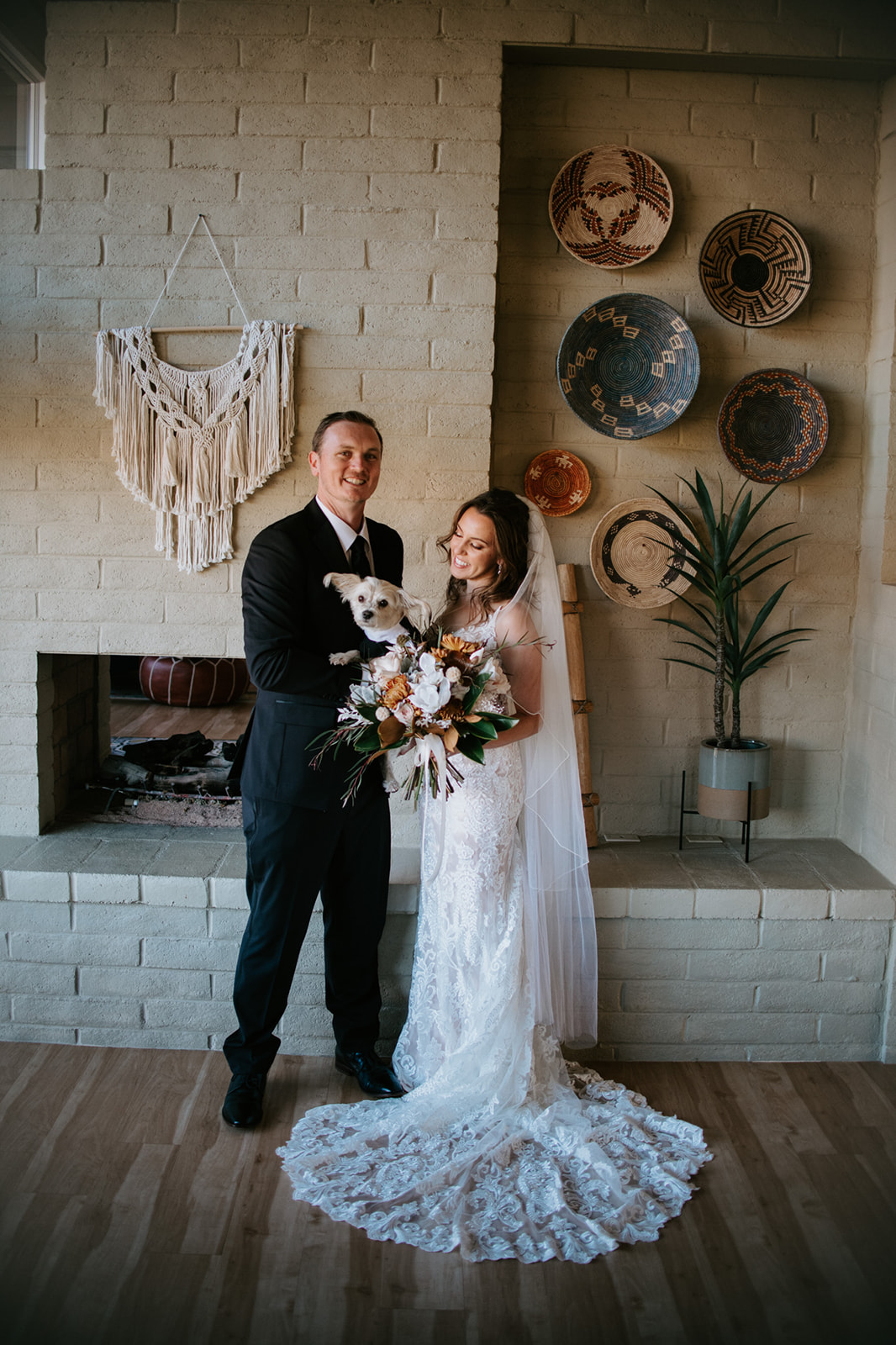 Bride and groom holding their dog indoors after their Arizona elopement ceremony
