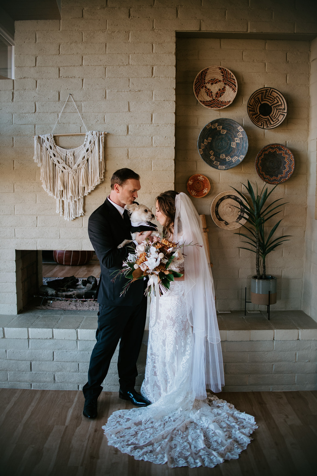 Couple sharing a quiet moment with their dog inside a cozy Sedona Airbnb
