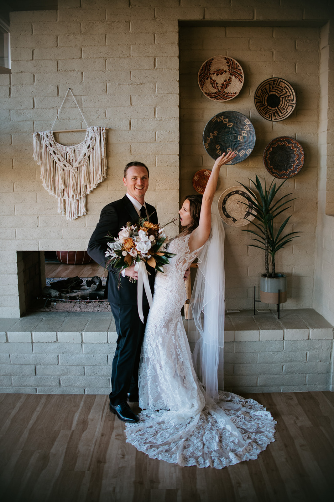 Bride and groom celebrating together inside a cozy Airbnb with desert-inspired decor and warm tones
