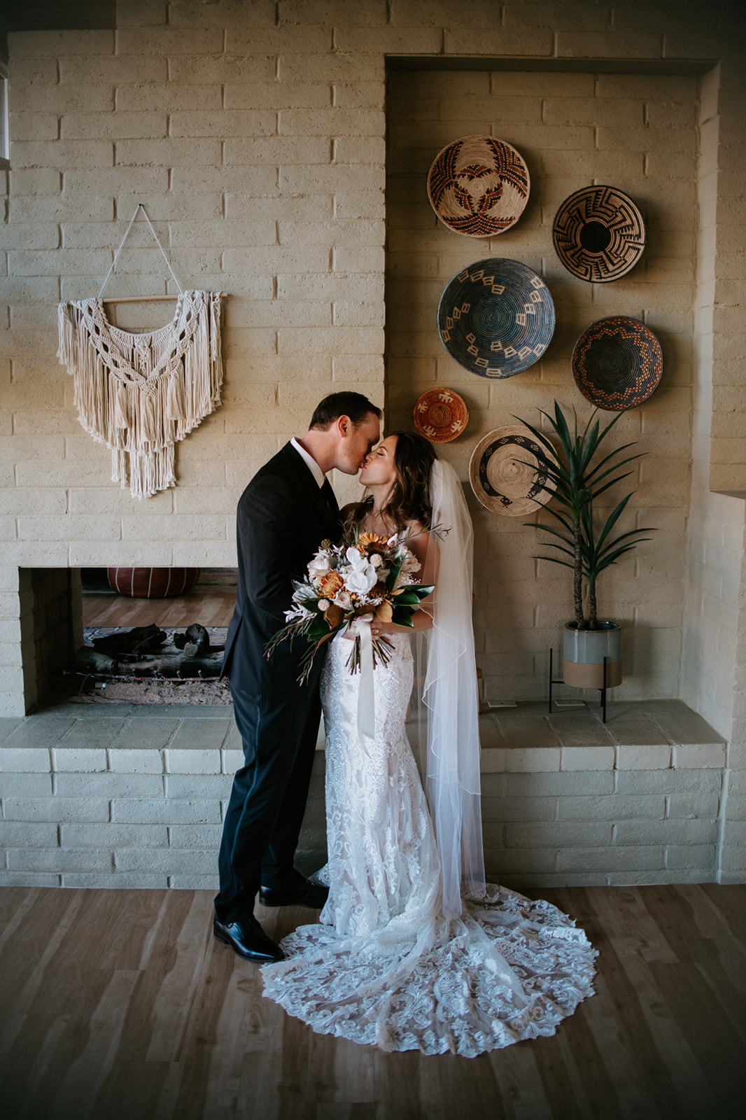 Bride and groom sharing a kiss indoors in a styled Airbnb space after their elopement in Arizona
