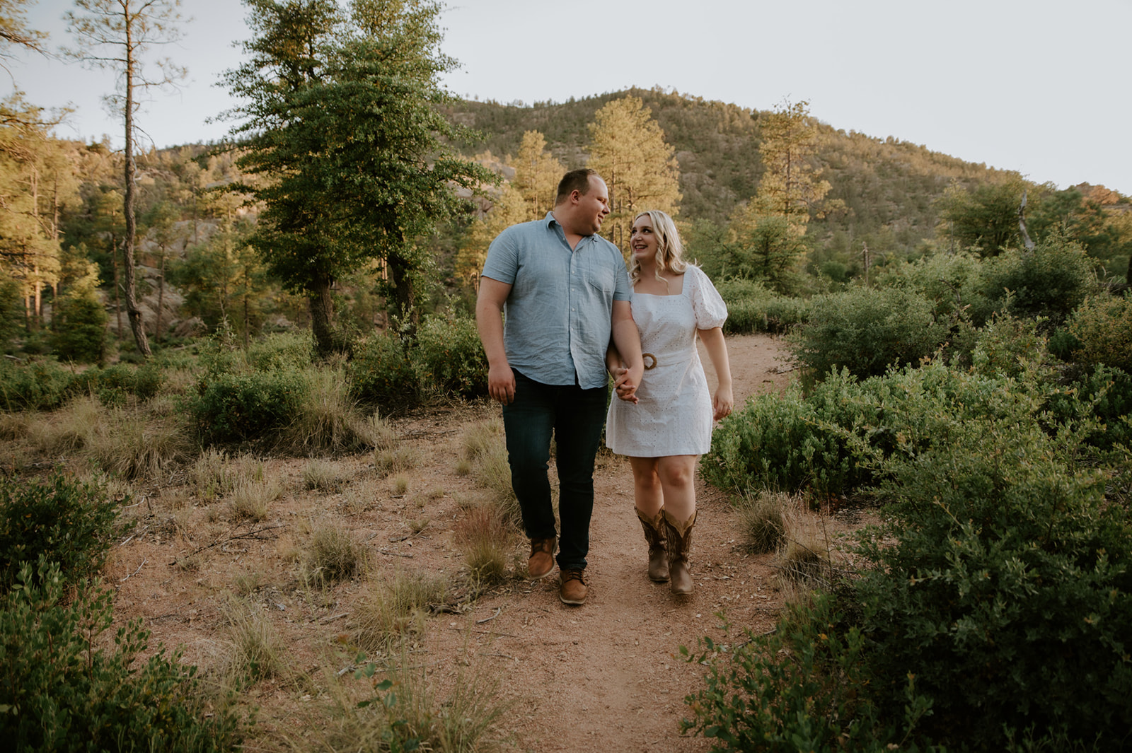 Couple walking together on a scenic path in Flagstaff, perfect inspiration for adventure elopements
