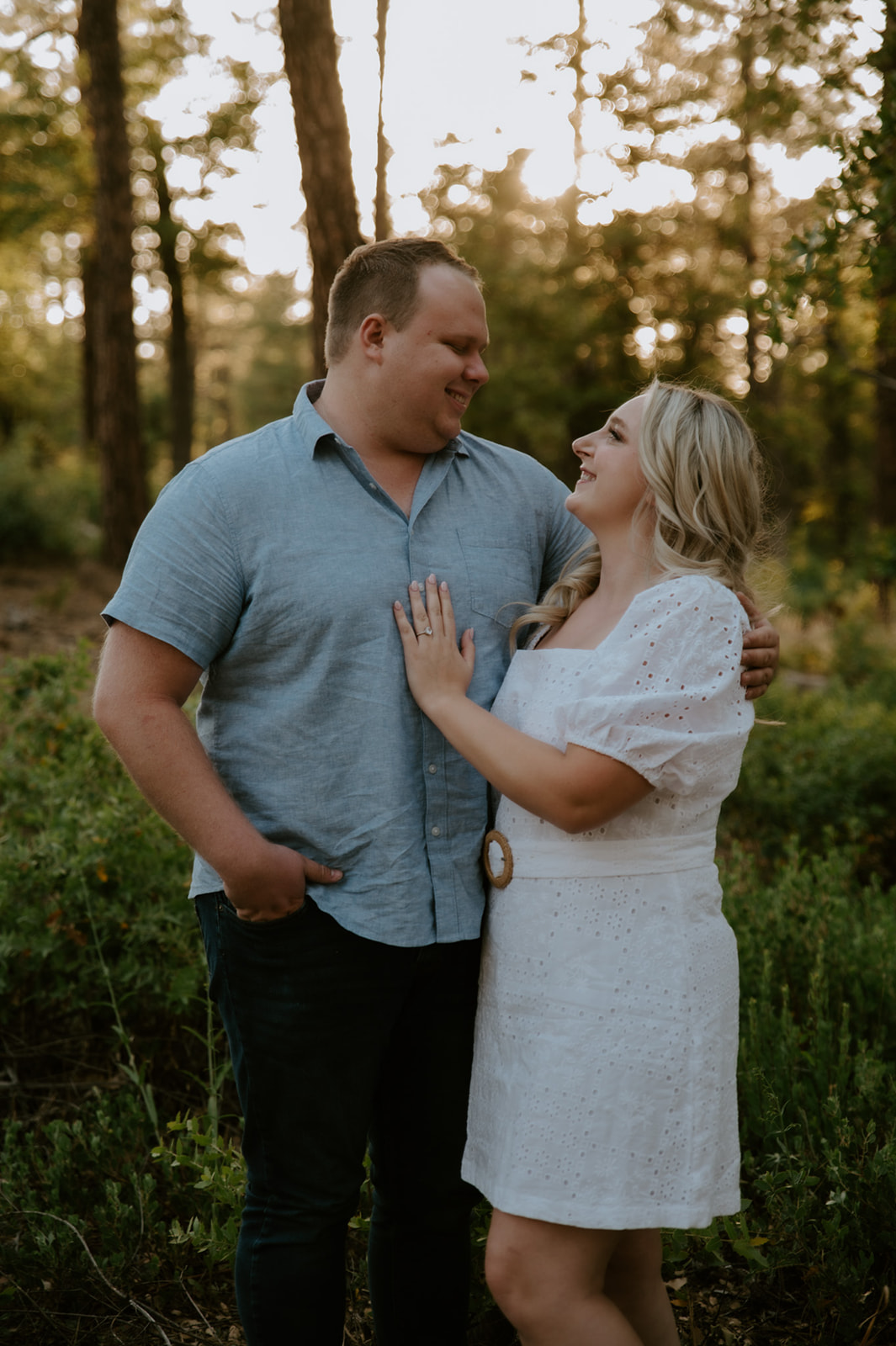 Couple smiling at each other in a wooded Arizona setting, capturing the relaxed feel of adventure elopements
