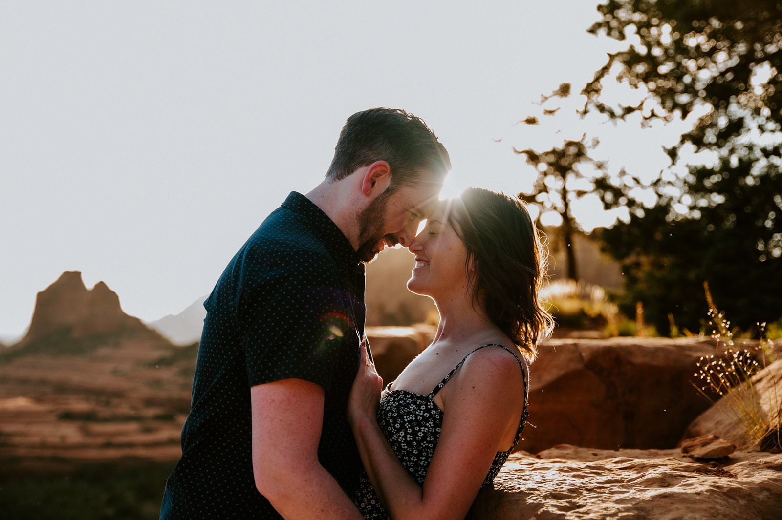 Intimate close-up of a couple leaning in together with warm sunlight during their decision to elope to Sedona