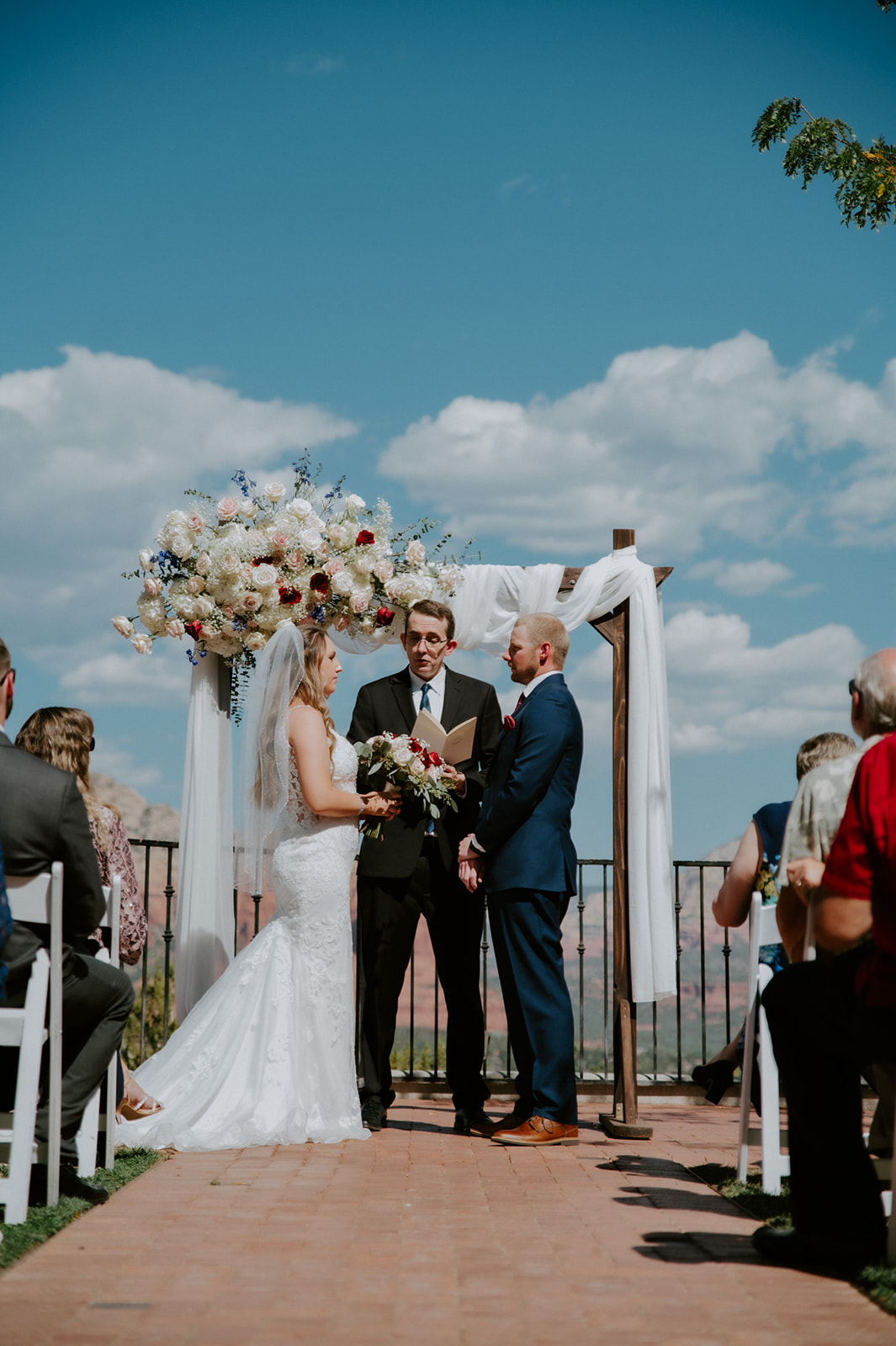 Intimate ceremony moment with officiant and guests gathered as a couple elopes in Sedona