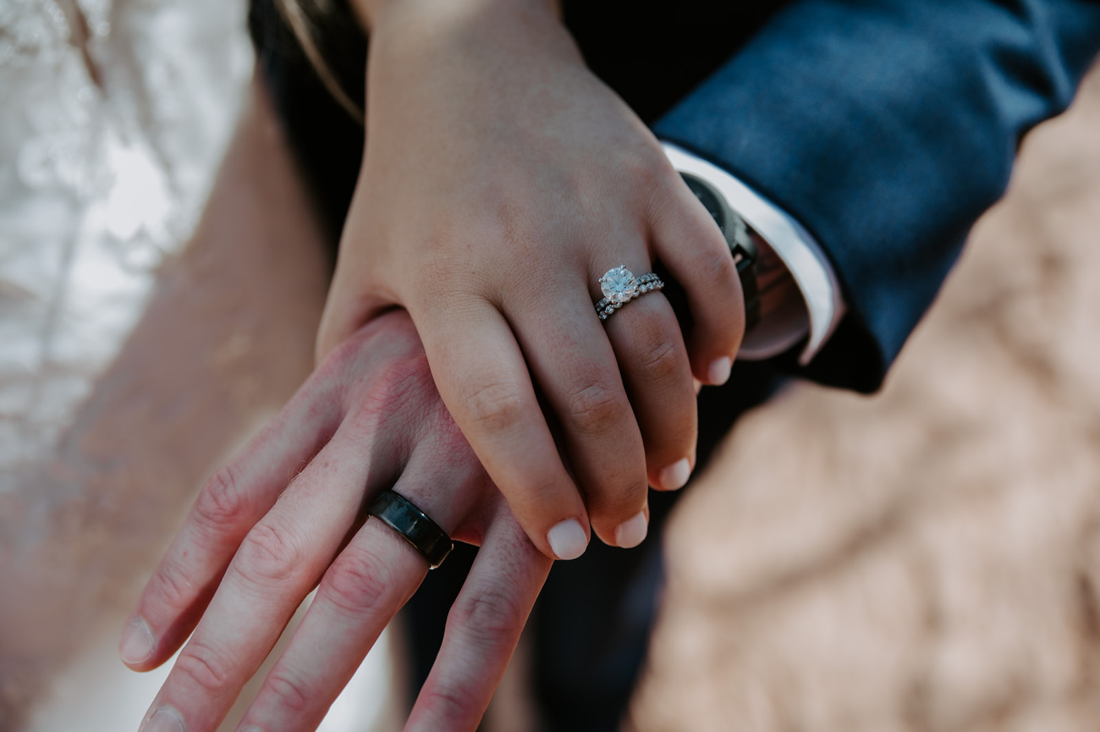 Close-up of wedding rings as a couple holds hands during their Sedona elopement