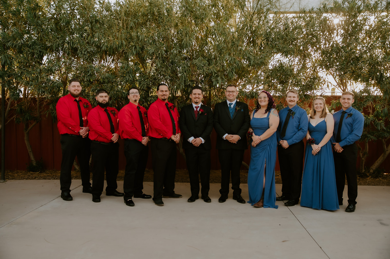 LGBTQ wedding party portraits with bridesmaids and groomsmen during an outdoor wedding celebration