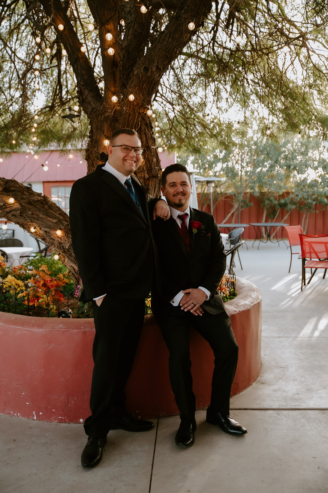Two grooms posing together during golden hour portraits photographed by an LGBTQ wedding photographer