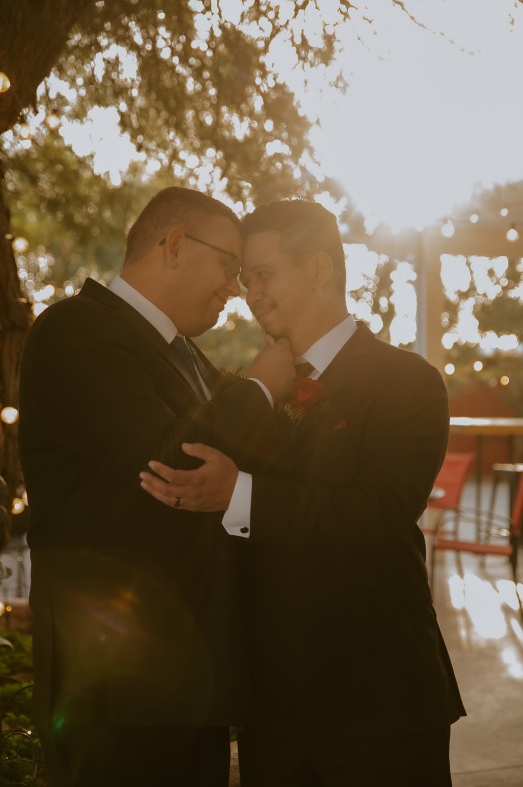 Romantic golden hour portrait of two grooms during an intimate wedding photographed by an LGBTQ wedding photographer