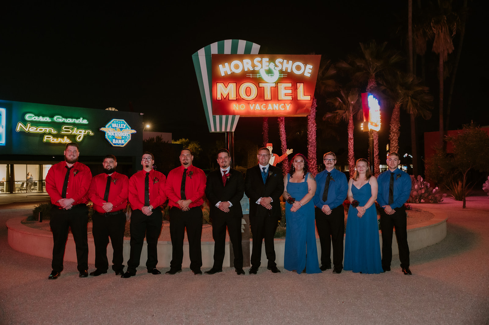 Wedding party posing outside the Horseshoe Motel during a retro-inspired same-sex wedding celebration