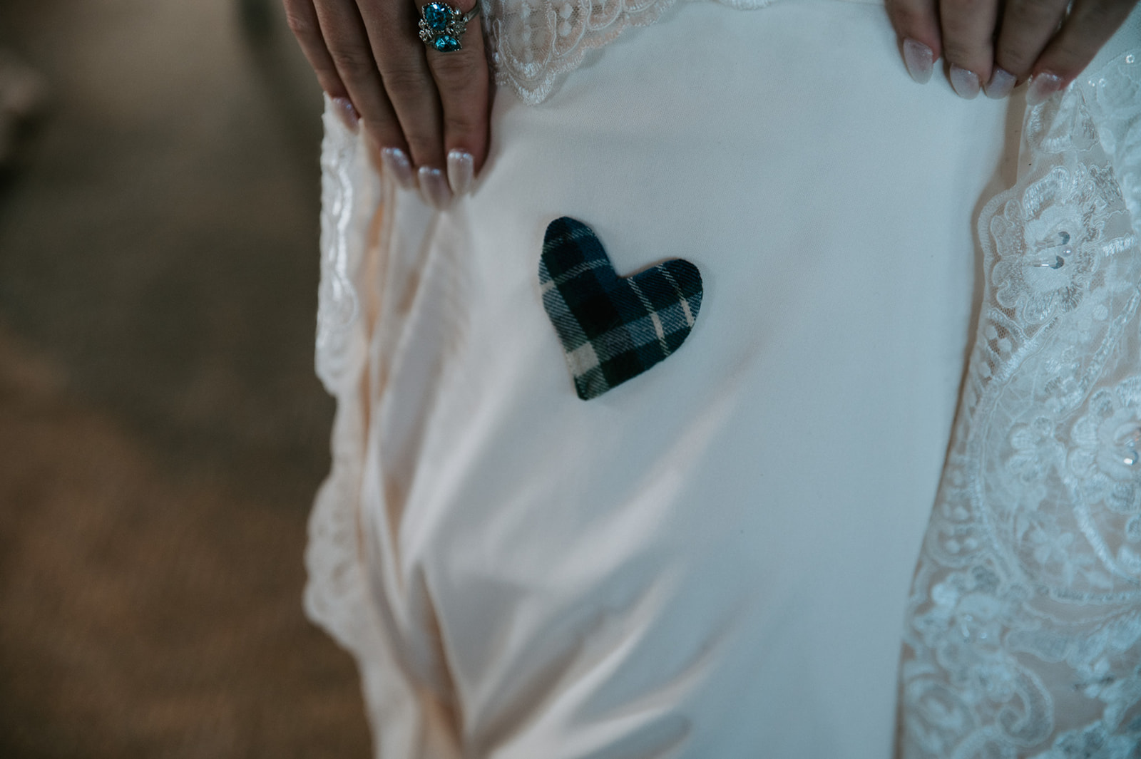 Hidden tartan heart sewn inside the wedding dress as a sentimental “something blue” detail.
