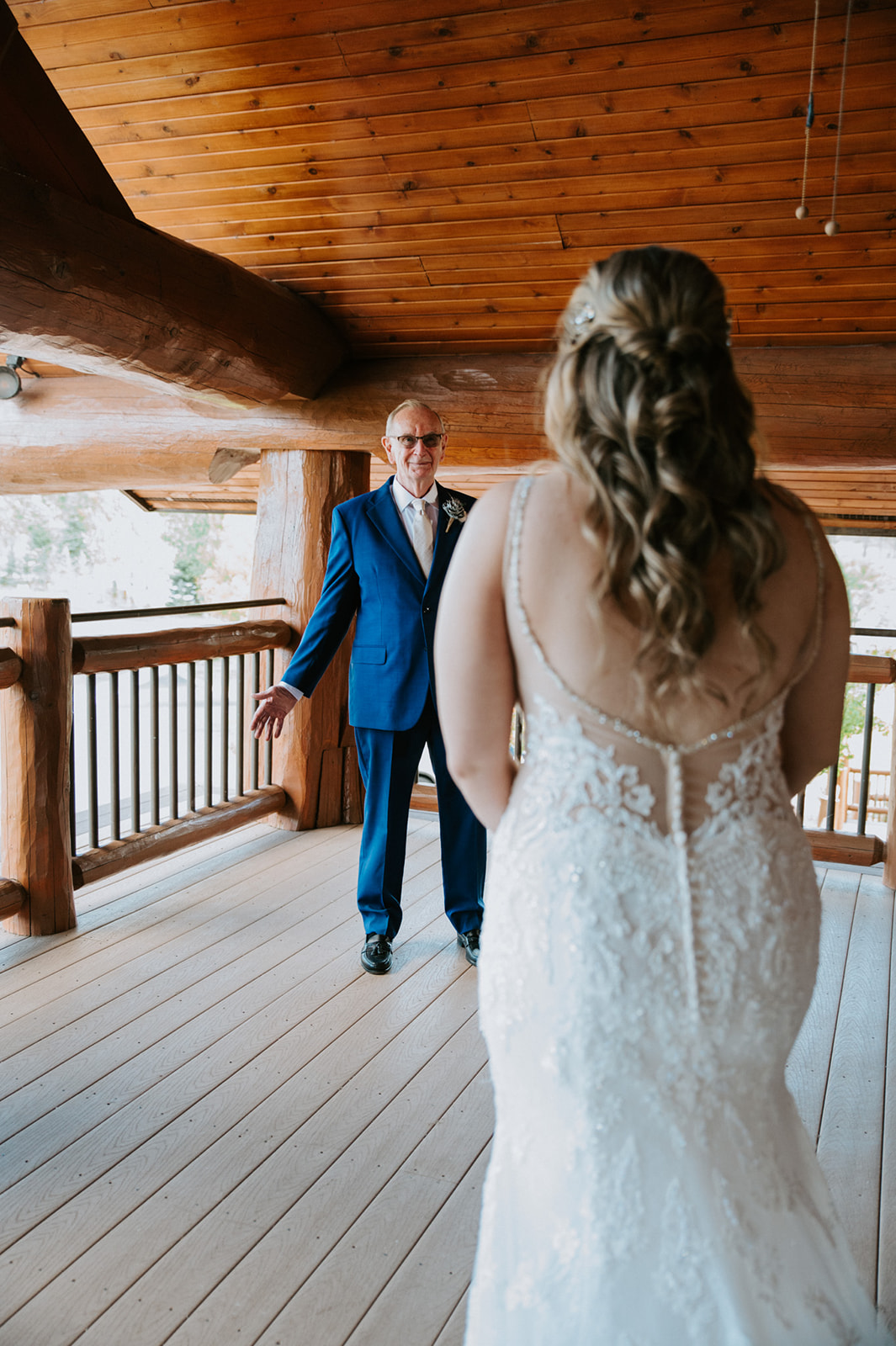 Father reacts with joy during a first look as he sees his daughter in her wedding dress for the first time.
