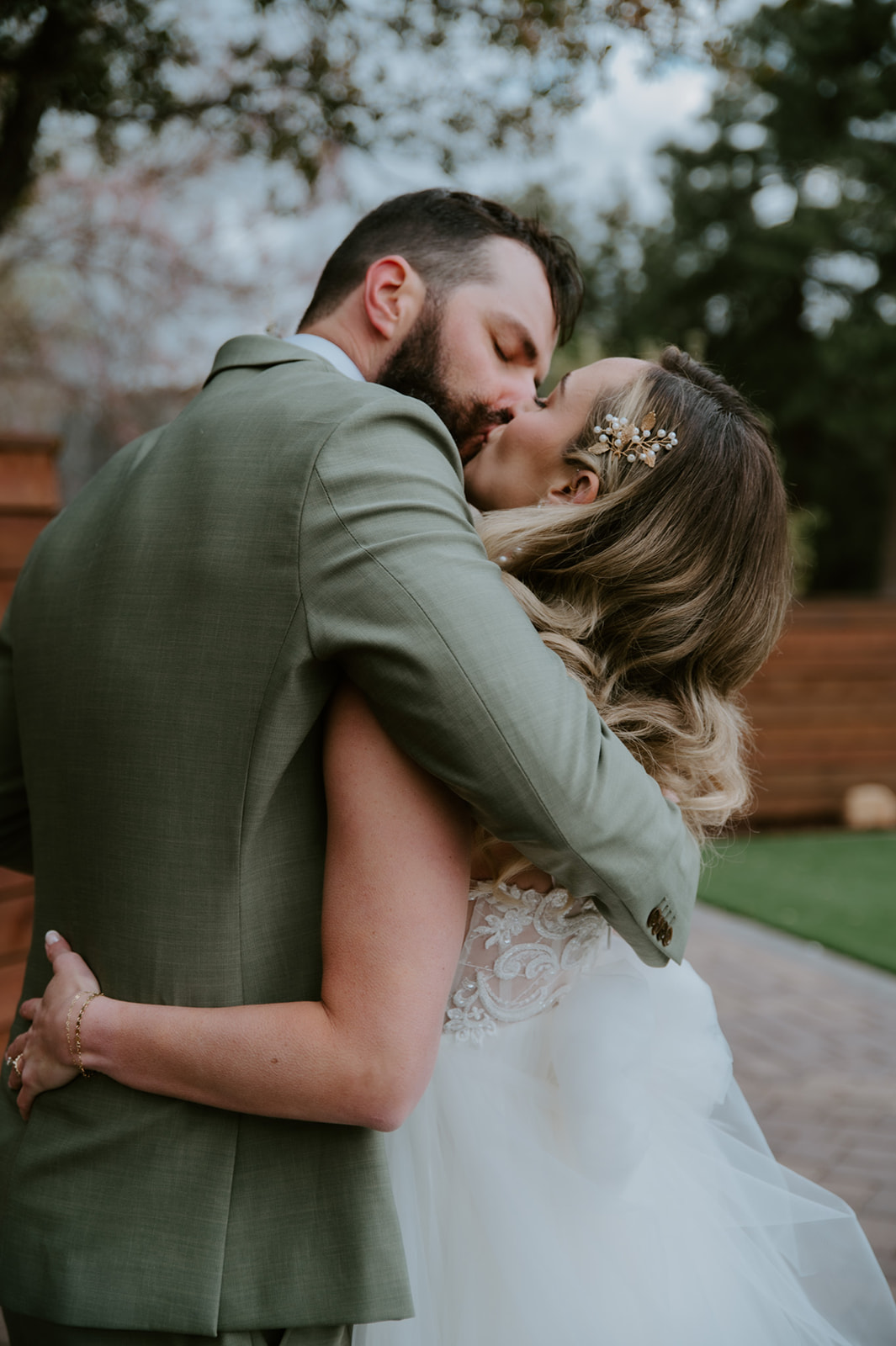 Close-up of the bride and groom embracing and kissing after their ceremony.

