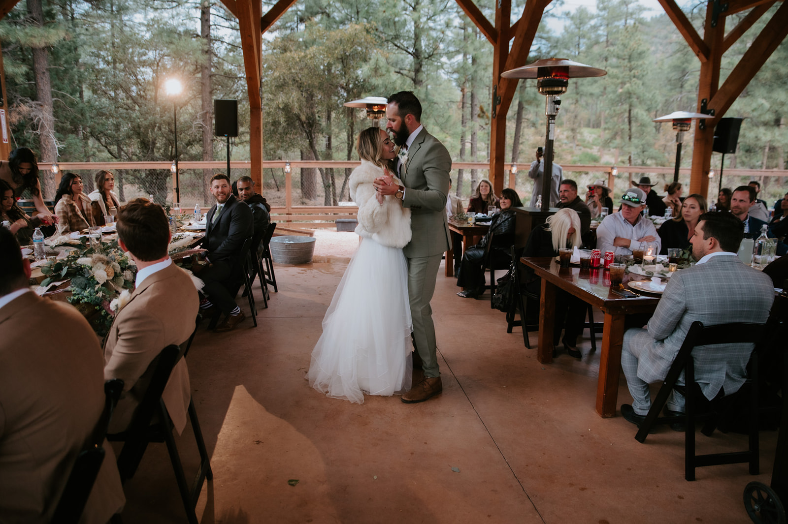 Bride and groom share their first dance surrounded by family and friends at the reception at cabins at strawberry hill.
