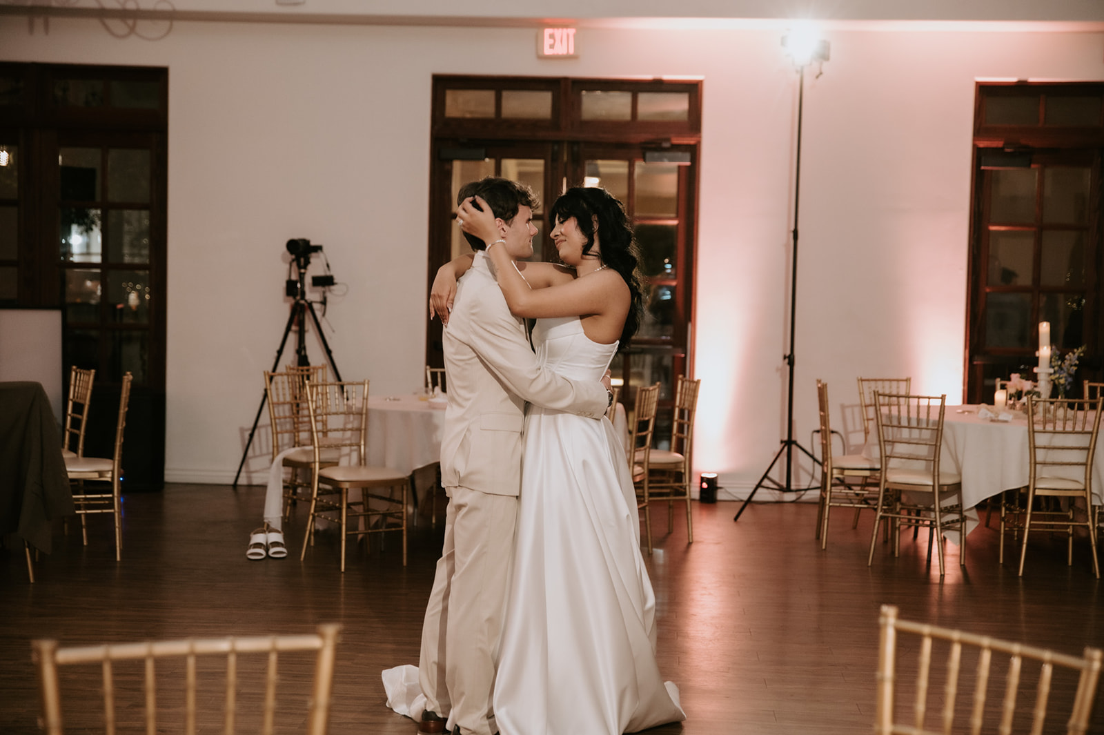 Bride and groom share a romantic dance together during their wedding reception.
